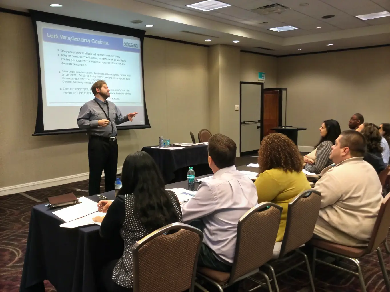 A trainer conducting a workshop with engaged participants, illustrating training and development services.